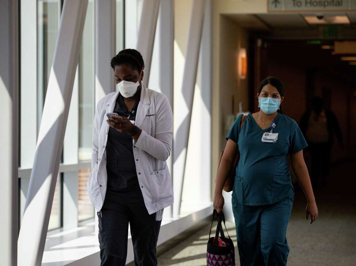Medical professionals can be seen leaving Houston Methodist West Hospital on Wednesday, July 28, 2021, in Katy.