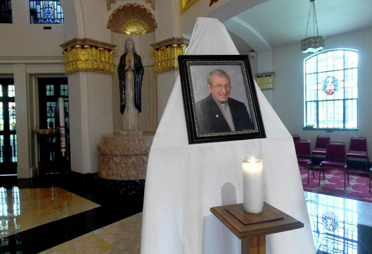 A candle sits in front of a photograph of Father William Manger on the altar at St. Anne Catholic Church in Beaumont, where a special mass was held in memorial of Fr. Manger, who passed away Monday. Photo made Tuesday, August 3, 2021 Kim Brent/The Enterprise