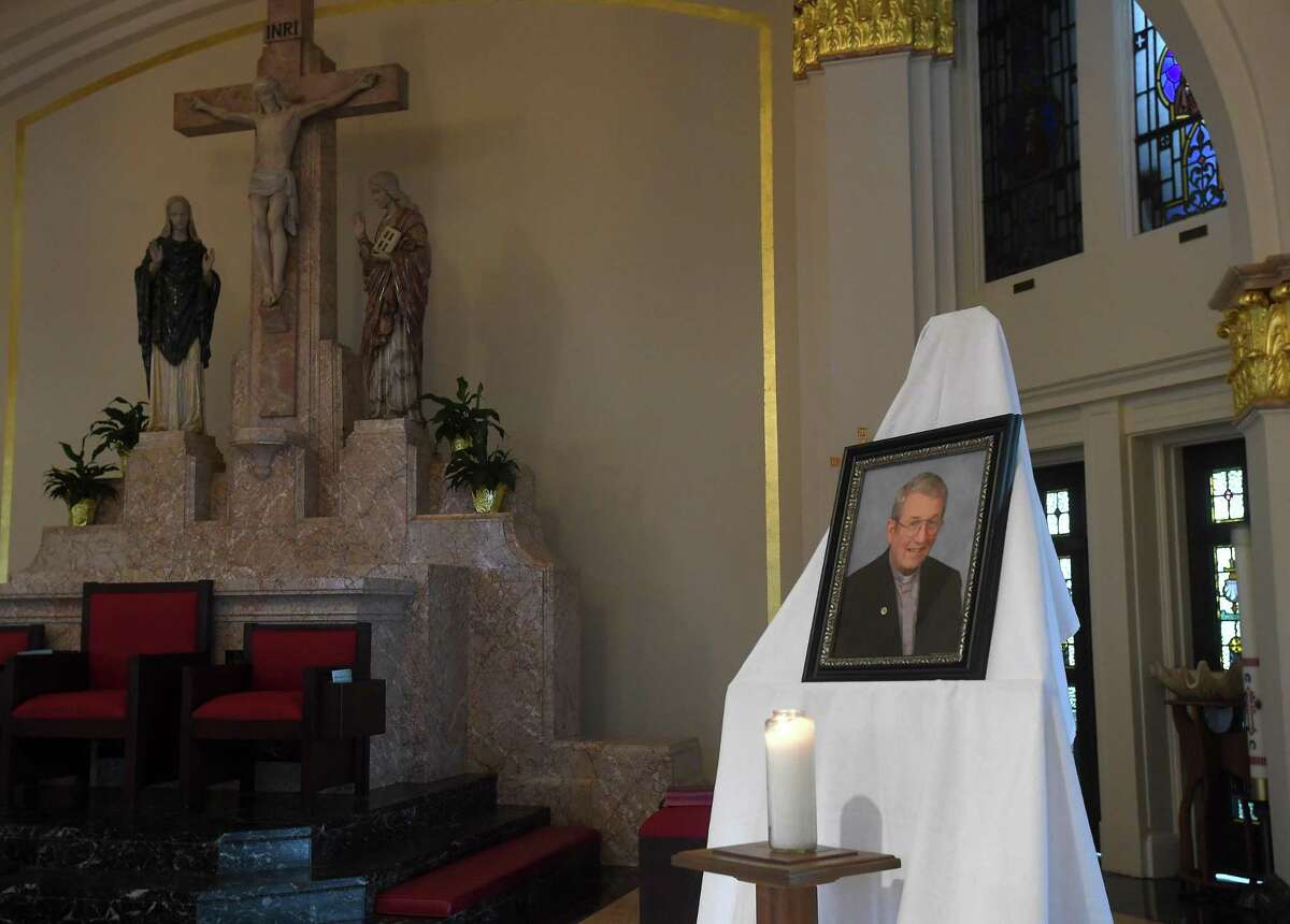 A candle sits in front of a photograph of Father William Manger on the altar at St. Anne Catholic Church in Beaumont, where a special mass was held in memorial of Fr. Manger, who passed away Monday. Photo made Tuesday, August 3, 2021 Kim Brent/The Enterprise