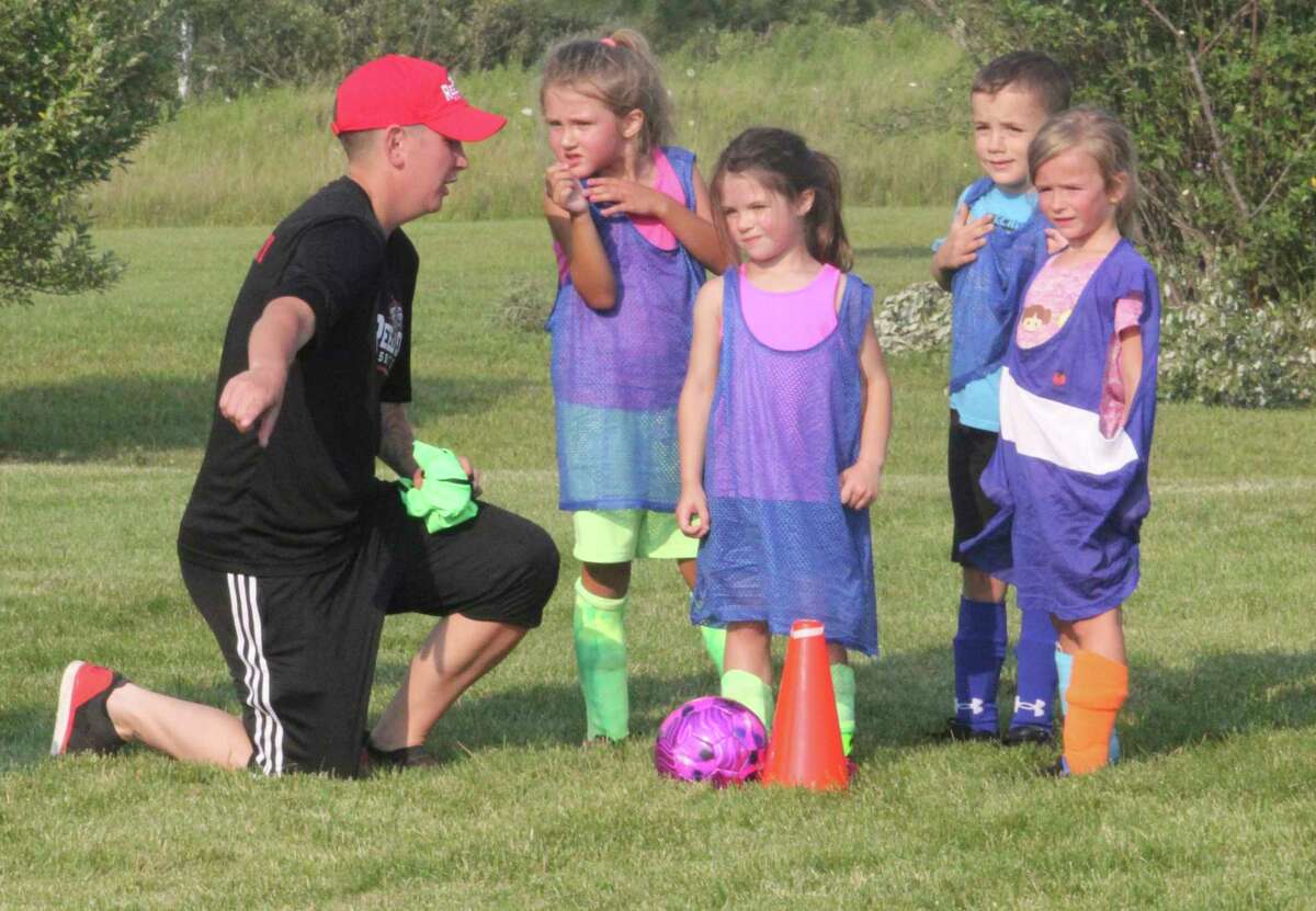 Reed City High School players worked with youngsters at the soccer camp last week. (Herald Review photo/John Raffel)