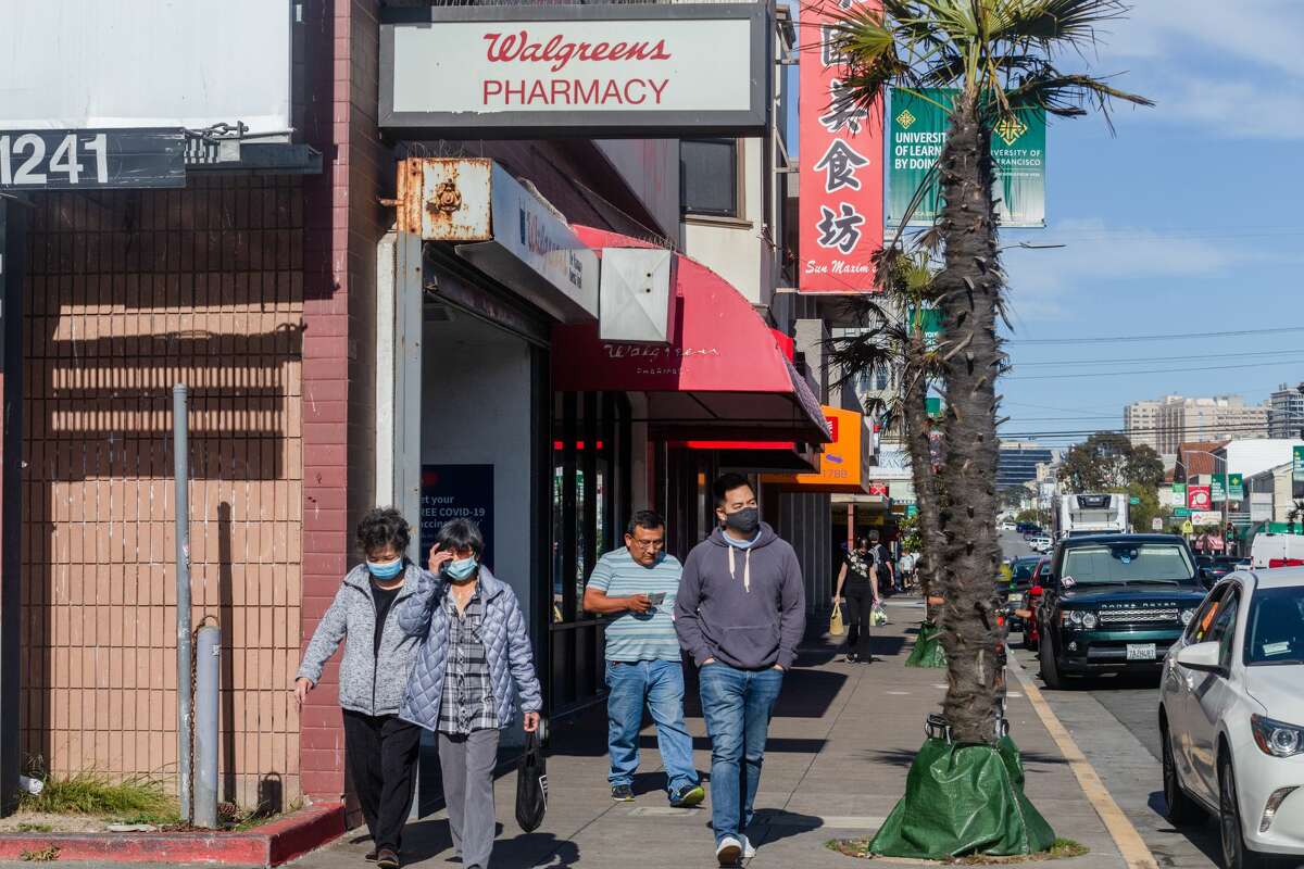 Masked customers and one unmasked exit Walgreens on Irving Street in the Outer Sunset on Monday afternoon, Aug. 2, 2021. 