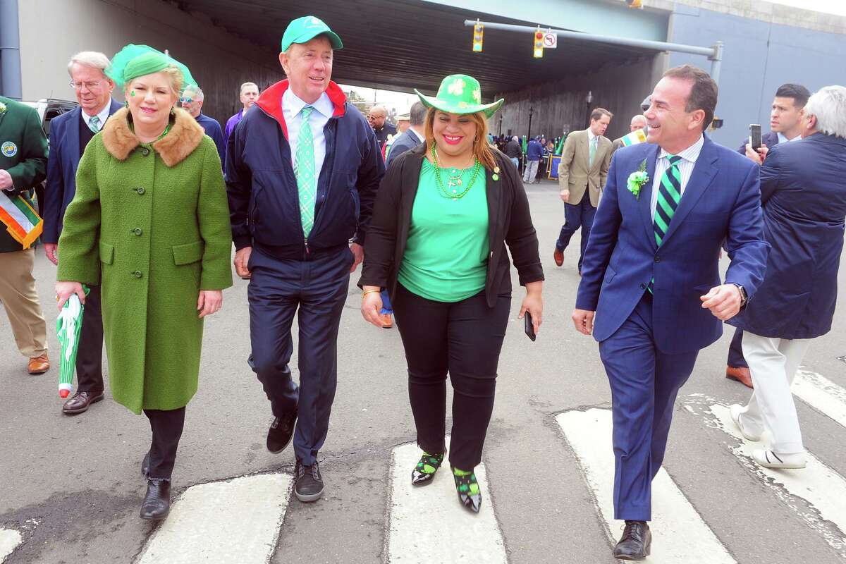 Gov. Ned Lamont and Mayor Joe Ganim are joined by Bridgeport City Council members Michelle Lyons, left, and Aidee Nieves, during the Greater Bridgeport St. Patrick’s Day Parade, in downtown Bridgeport, Conn. March 15, 2019.