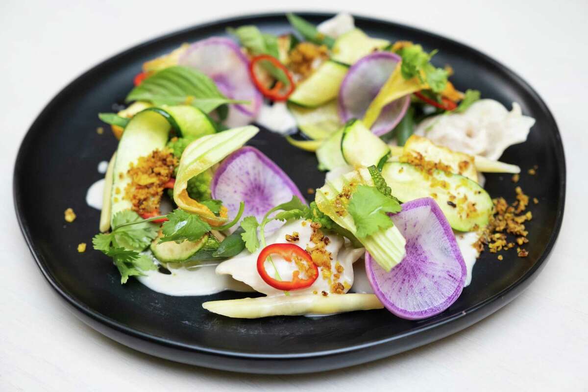 Squash balls are surrounded by seasonal vegetables and coconut sauce at Abacá in San Francisco.