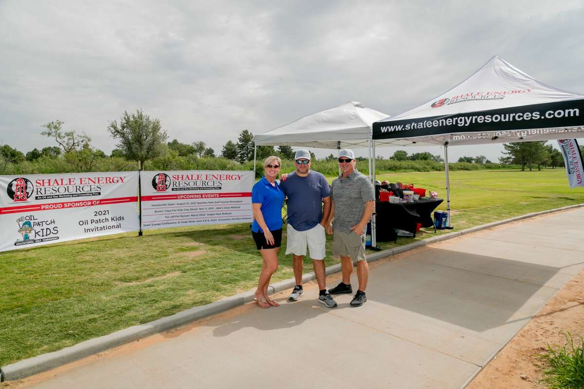 From left Miranda Kennedy, Jeff Kennedy and Arnie Alexander photographed at the title sponsor Shale Energy tent during the Oil Patch Kids golf tournament July 16, 2021 at Hogan Park Golf Course in Midland, Texas. Photo Credit: The Oilfield Photographer, Inc.