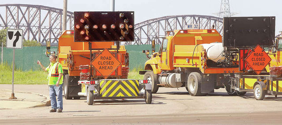 FILE - Illinois Department of Transportation workers closed the entrance to the McKinley Bridge, background, following two incidents on the bridge.