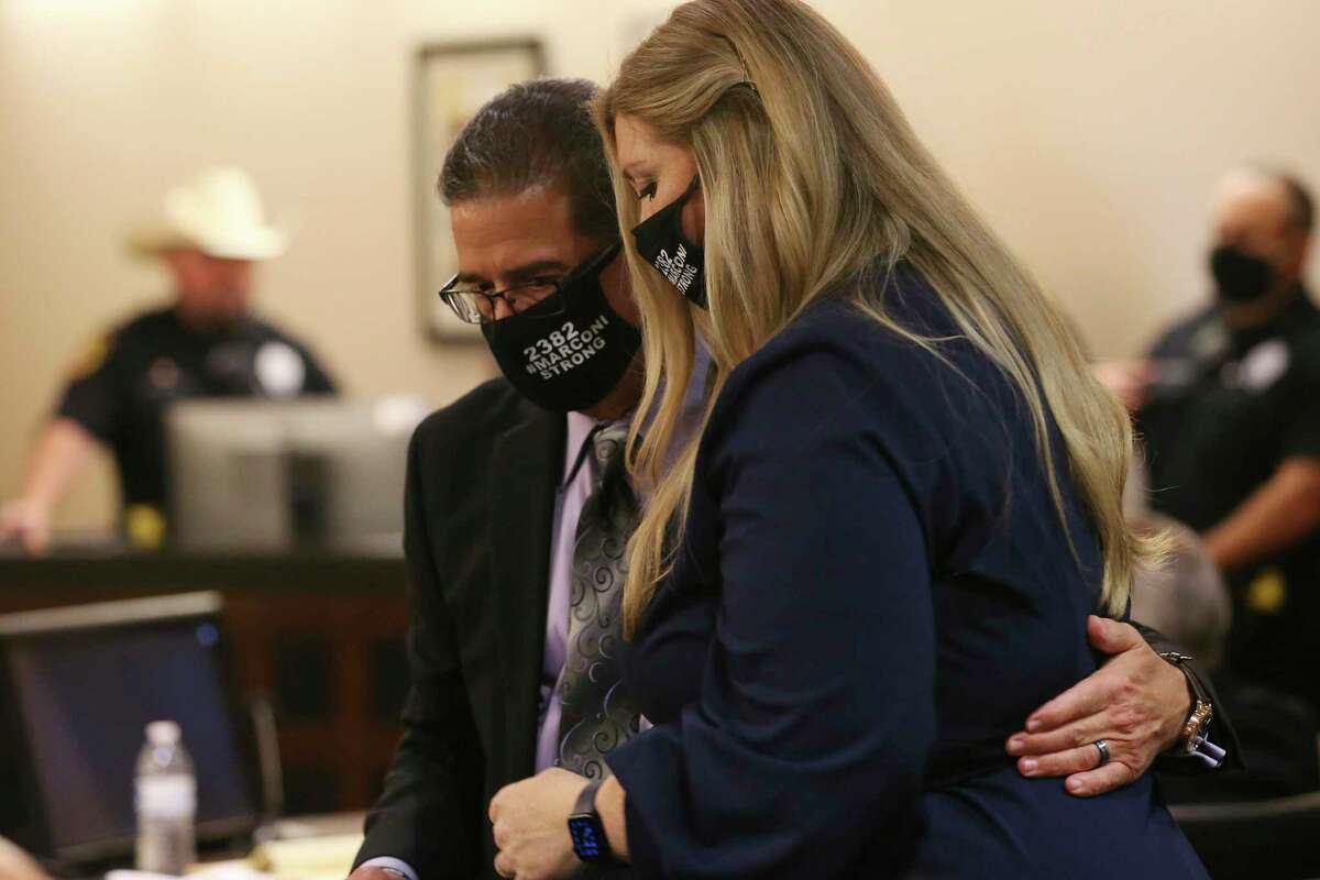 Tom Marconi hugs Jacy Reeves after both testified during day five of the punishment phase in the capital murder trial of Otis McKane in the Bexar County 379th District Court, Wednesday, Aug. 4, 2021. McKane was found guilty of murdering San Antonio police Detective Benjamin Marconi on Nov. 20, 2016. Marconi is the victim?•s older brother and Reeves is the victim?•s stepdaughter.