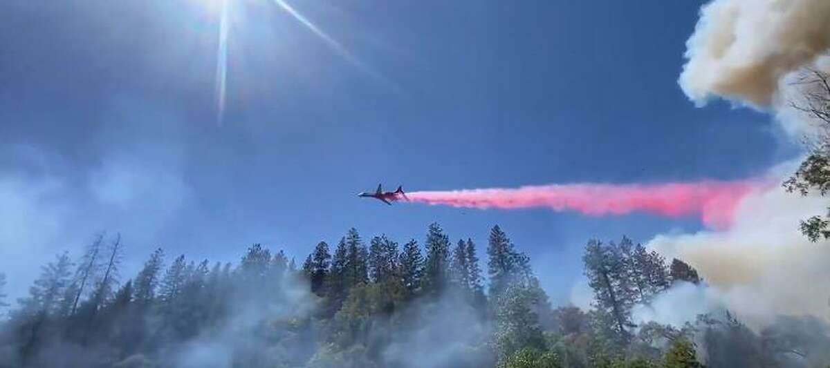 A plane drops fire retardant on the River Fire on Aug. 4, 2021.