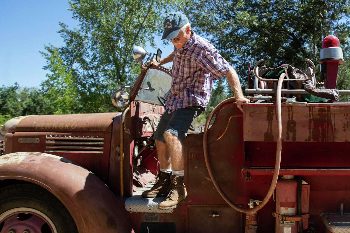 Randy Dunn, of Dunn Vineyards in Angwin, hops out of a 1946 fire truck he bought to protect his winery from wildfires. Dunn has been trying to bolster firefighting efforts in Napa Valley.