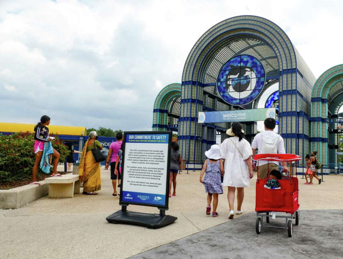 A sign placed by the front entrance of SeaWorld San Antonio informs guests about masking policies on Tuesday, Aug. 3, 2021.