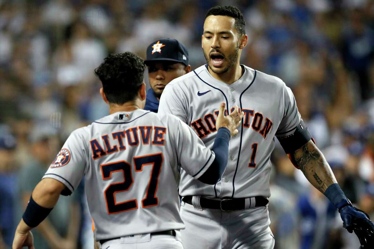 Houston Astros' Carlos Correa, right, celebrates his solo home run with Jose Altuve against the Los Angeles Dodgers during the eighth inning of a baseball game in Los Angeles, Wednesday, Aug. 4, 2021. (AP Photo/Alex Gallardo)