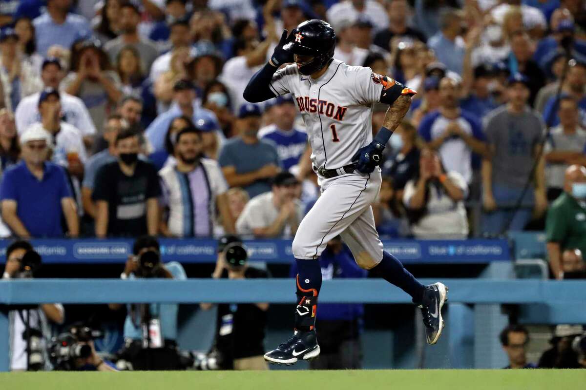 Houston Astros' Carlos Correa reacts to the fans after hitting a solo home run against the Los Angeles Dodgers during the eighth inning of a baseball game in Los Angeles, Wednesday, Aug. 4, 2021. (AP Photo/Alex Gallardo)