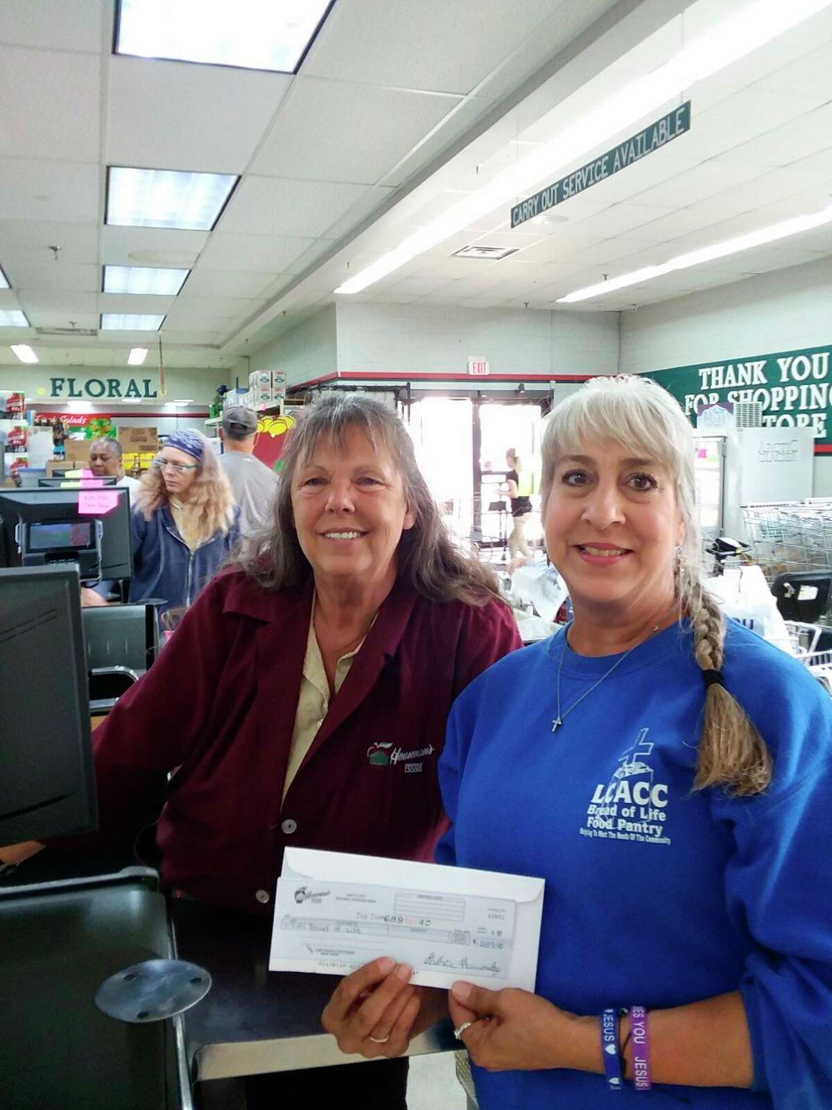 Bread of Life Pantry director, Lynne Mills (right) accepts a donation check for $689.40 from Houseman's Food employee Marlene Schofield (left). Schofield collect the most donations during the Dollar at Checkout campaign over the July 4 weekend. (Submitted photo) 