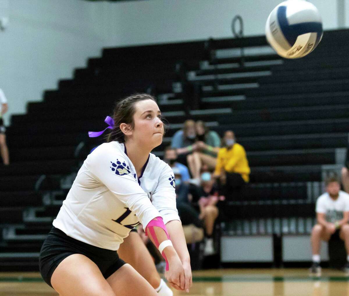 Montgomery libero Kendall Sadler (12) returns a serve during the second set of a District 20-5A volleyball match at Kingwood Park High School in Kingwood.