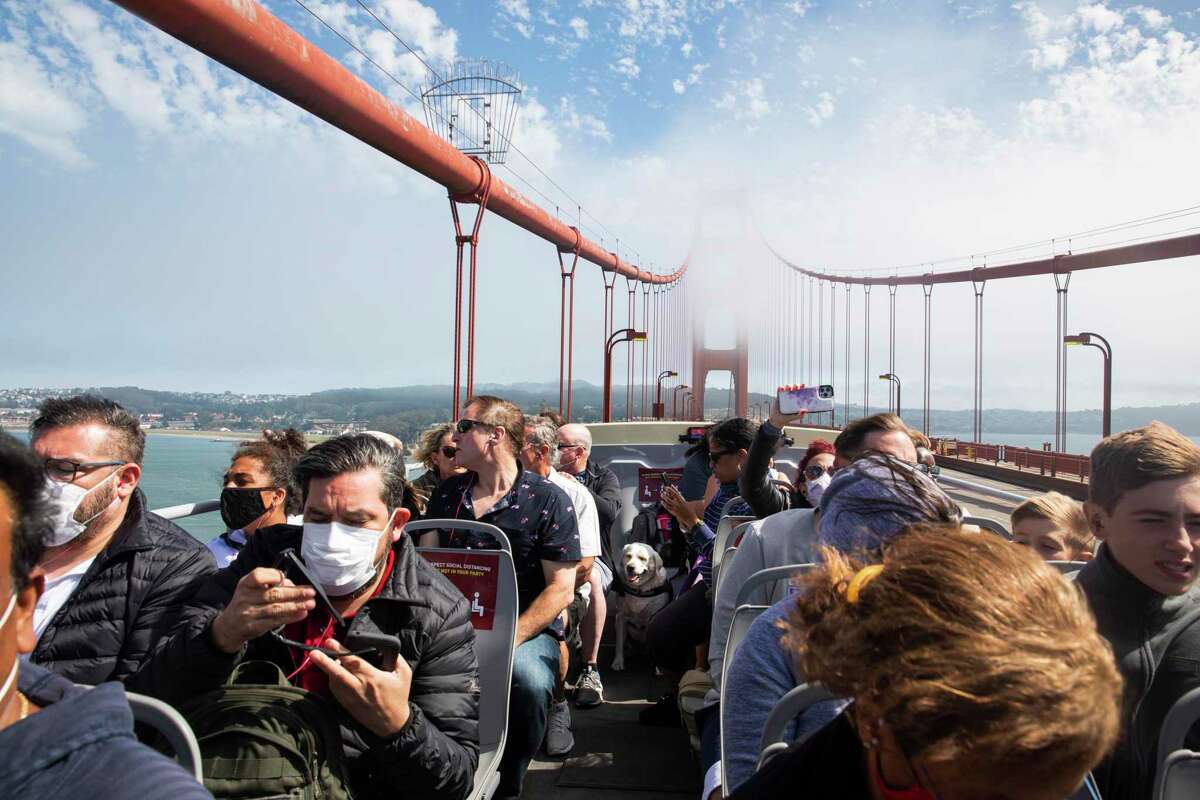 Tourists enjoy a ride on the double-decker Big Bus Tour across the Golden Gate Bridge in San Francisco, Calif., on Tuesday, July 27, 2021. Tourists came to visit San Francisco all the way from Dubai to Atlanta, GA.