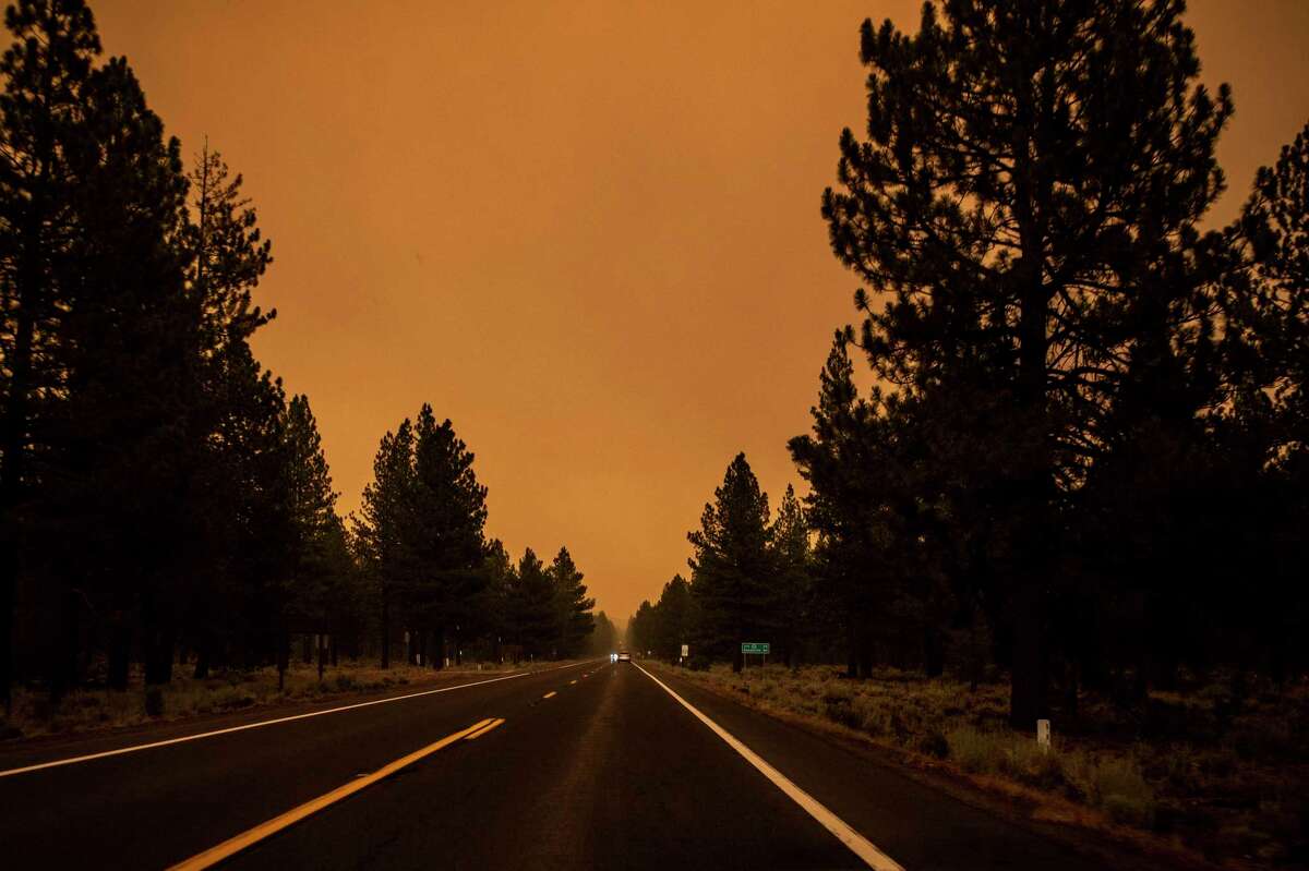 The sky is seen with an orange hue along Highway 44 during the Dixie Fire in Lassen County this week.