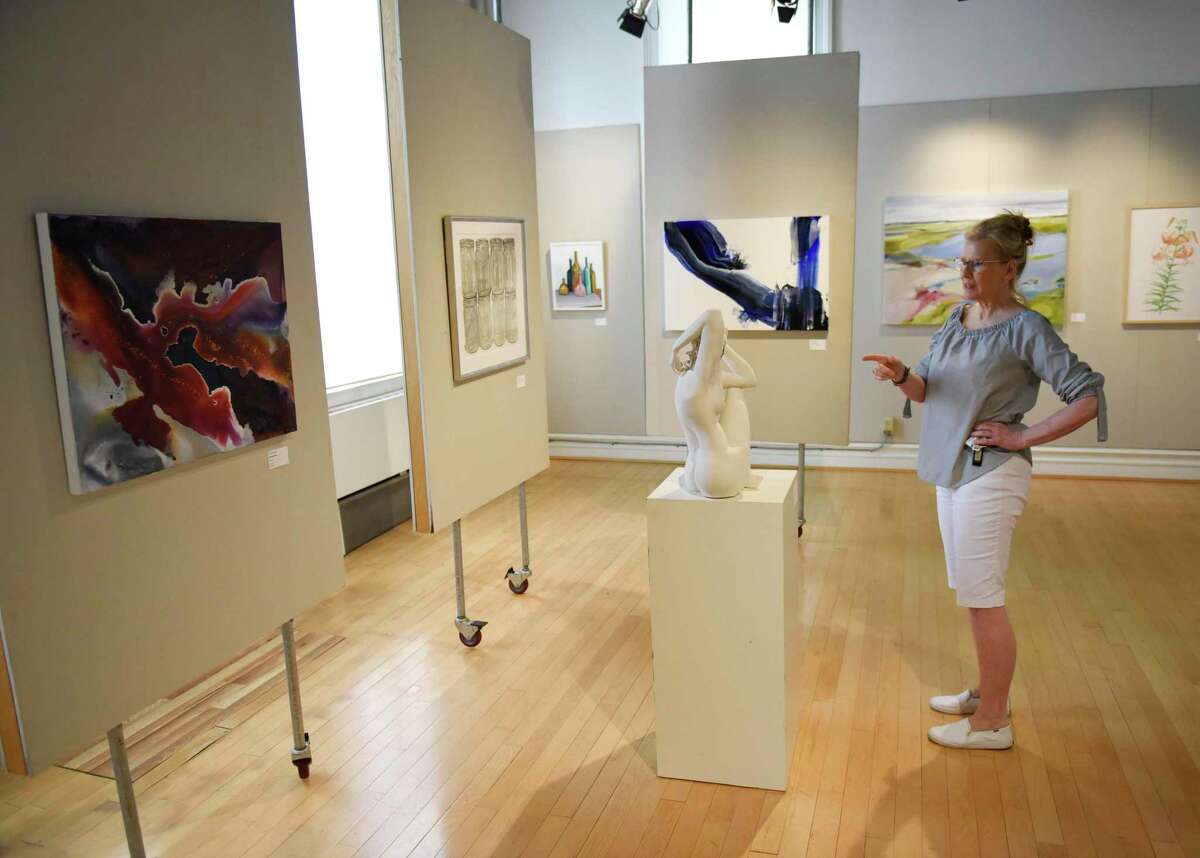Greenwich Art Society Co-Director Mary Newcomb looks at Jocelyn Braxton Armstrong's porcelain sculpture "For Lee IX" at Greenwich Art Society's 104th Annual Juried Exhibition at the Bendheim Gallery in Greenwich, Conn. Tuesday, July 27, 2021. The artwork, in a variety of mediums, was judged by Allison Rudnick, Associate Curator in the department of Drawings and Prints at the Metropolitan Museum of Art.