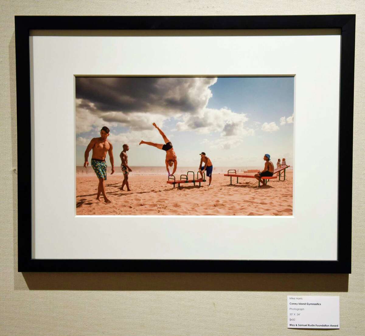 Mike Harris' photograph "Coney Island Gymnastics" is displayed as part of Greenwich Art Society's 104th Annual Juried Exhibition at the Bendheim Gallery in Greenwich, Conn. Tuesday, July 27, 2021. The work, in a variety of mediums, was judged by Allison Rudnick, Associate Curator in the department of Drawings and Prints at the Metropolitan Museum of Art.