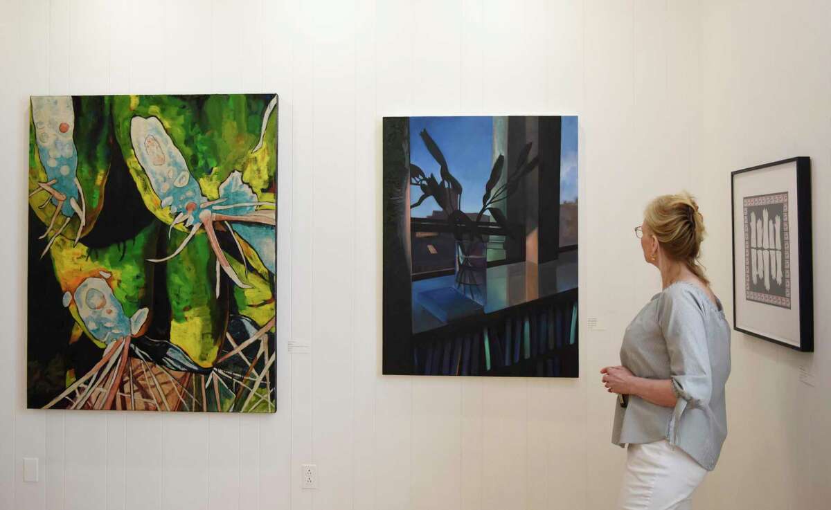 Greenwich Art Society Co-Director Mary Newcomb looks at work from the Greenwich Art Society's 104th Annual Juried Exhibition at the Bendheim Gallery in Greenwich, Conn. Tuesday, July 27, 2021. The work, in a variety of mediums, was judged by Allison Rudnick, Associate Curator in the department of Drawings and Prints at the Metropolitan Museum of Art.