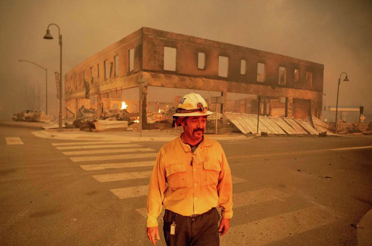 Battalion Chief Sergio Mora looks on as the Dixie Fire burns through downtown Greenville on Aug. 4.