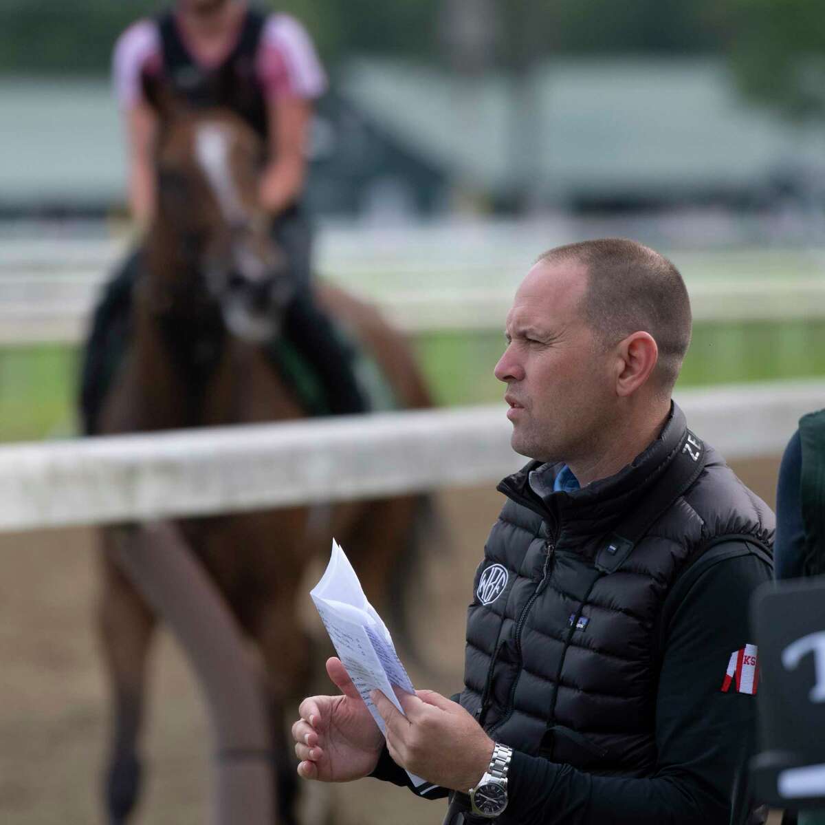 Trainer Chad Brown watches his trainees on the main track at Saratoga Race Course on Thursday, Aug 5, 2021, in Saratoga Springs, N.Y.