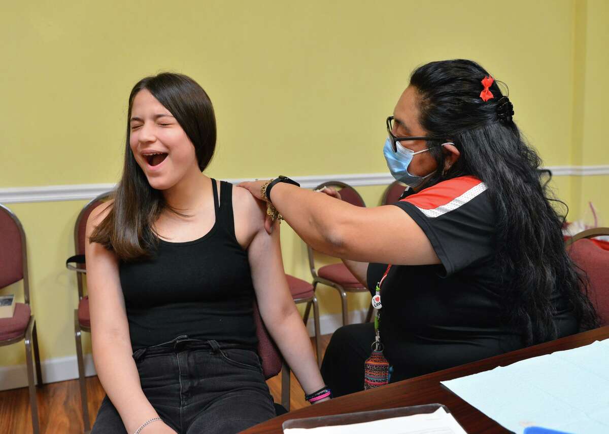 A teen receives a shot at a vaccine clinic hosted by University of the Incarnate Word at Greater Corinth Baptist Church. As health professionals find out more about the highly contagious delta variant, the community can use the lessons already learned to get through this surge.