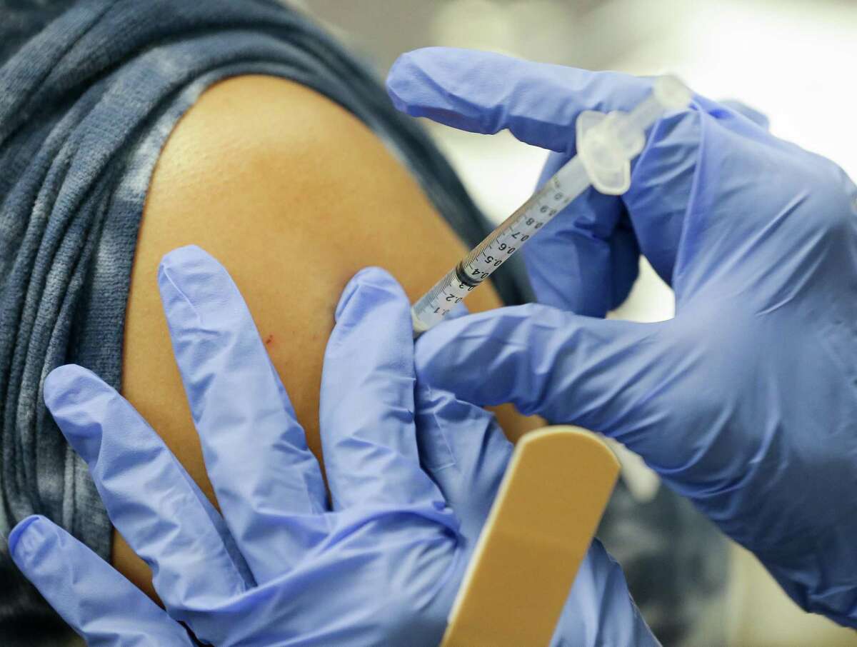 A registered nurse administers a dose of the Pfizer COVID-19 vaccine at Houston Methodist Sugar Land Hospital on Thursday, July 22, 2021, in Sugar Land.