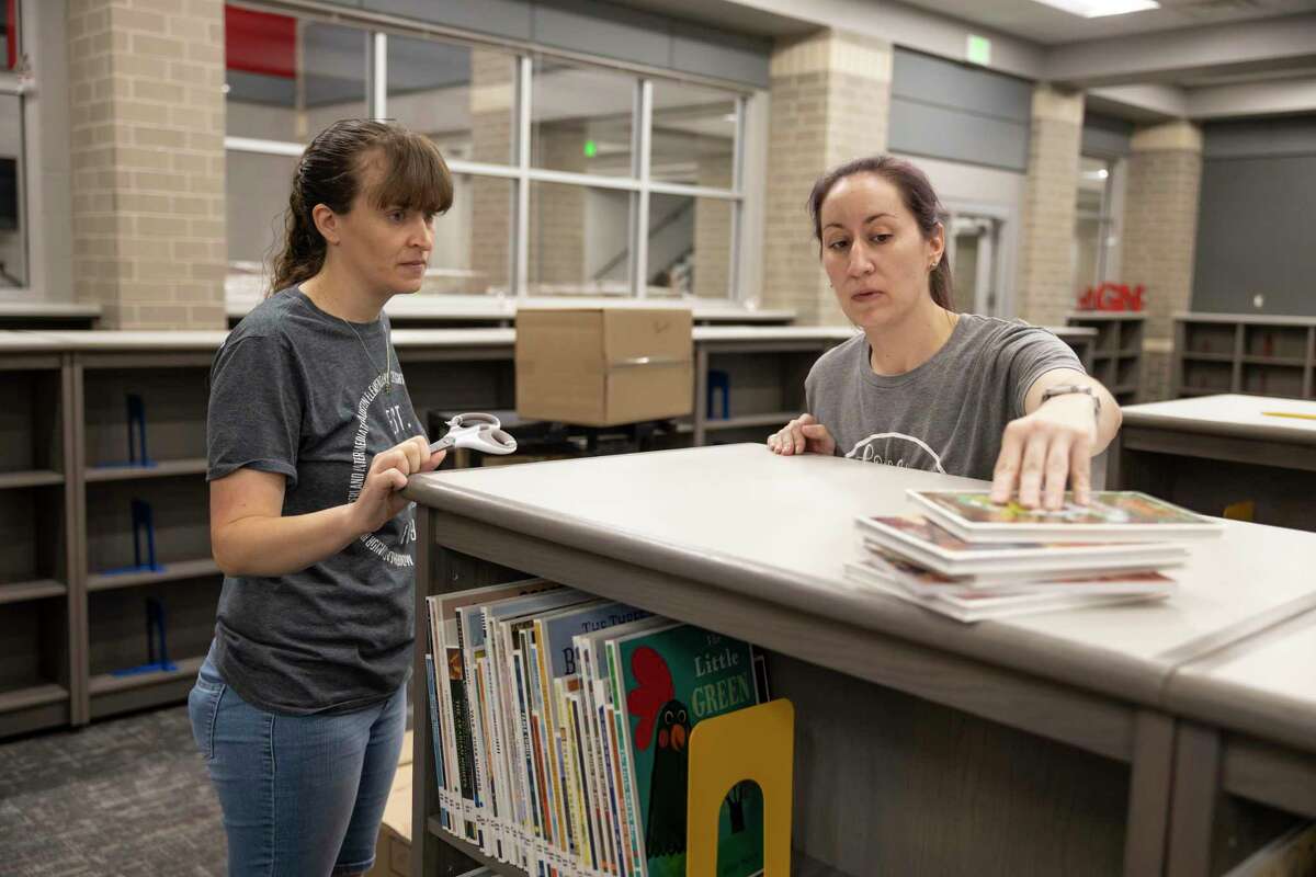 Shawna Prebish, right, librarian and Tracy Pippin, volunteer, determine where a book should be located in the library at Hope Elementary on July 22 in Conroe. Pallets of supplies were delivered to the school to assist teachers and staff in preparation for the upcoming school year. In a letter to local school boards and superintendents, Montgomery County Public Health Authority Dr. Charles Sims warned local schools of the danger that the delta variant poses to the upcoming school year.