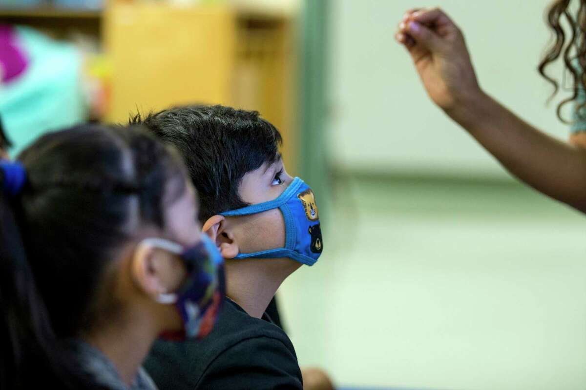 In this file photo from July 22, 2021, Christopher Flores Amaya listens in his kindergarten dual language class at Vines Primary School in Aldine ISD. Aldine ISD announced Wednesday that its mask mandate would remain in effect until further notice due to an upward trend in COVID cases, reversing its previous decision to rescind the requirement after the holiday break.