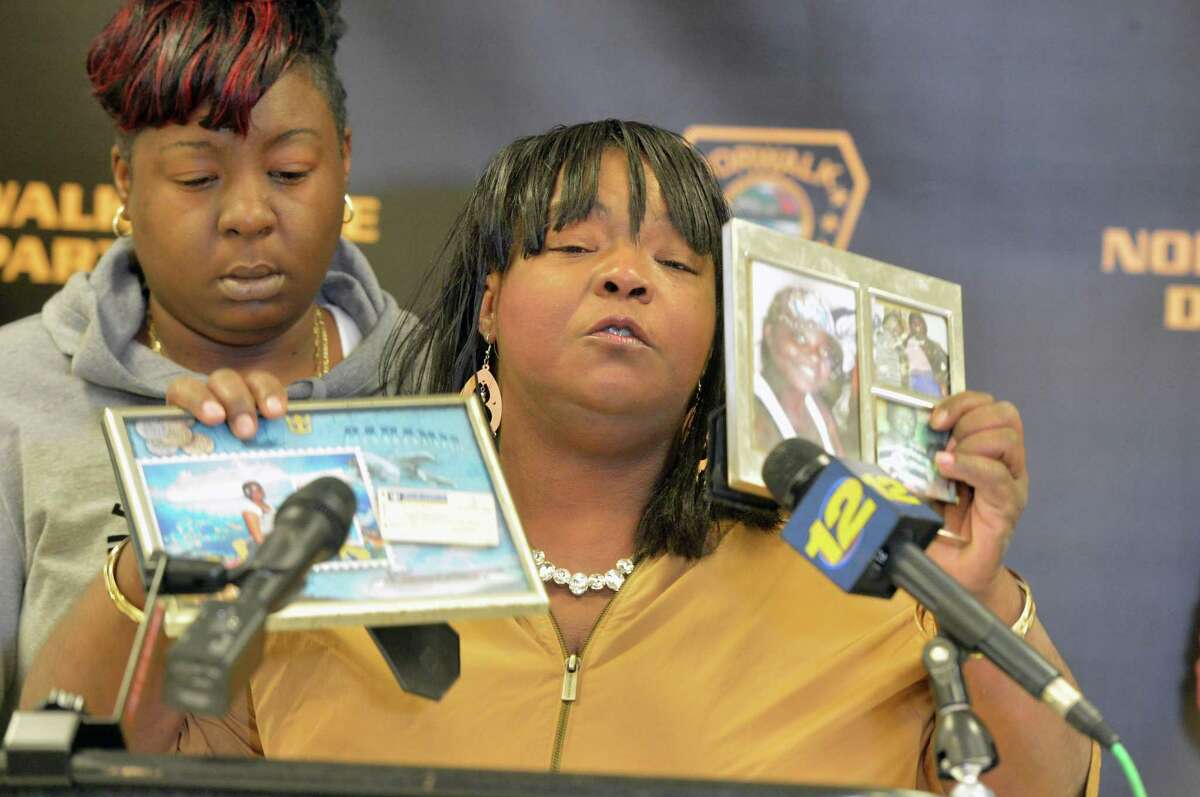 Barbara Smalls holds up photos of her granddaughter Rickita Smalls as she pleads for anyone having information about the August 6, 2011 murder of her and Iroquois Alston to please help, during at a press conference Monday November 13, 2017 at police headquarters in Norwalk Conn. to remind the public of a $50,000 reward leading to the arrest and conviction of the killer or killers.