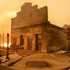 Battalion Chief Sergio Mora surveys a burned building as the Dixie Fire tears through downtown Greenville, California on August 4, 2021. 
