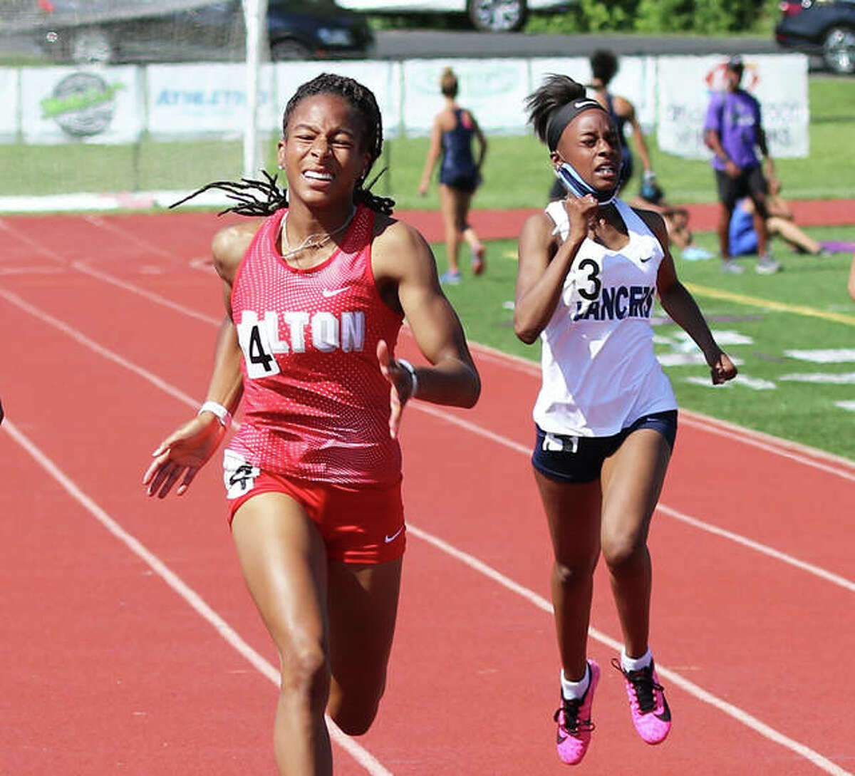 Alton junior Renee Raglin (left) wins the 200 meters to complete sprints sweep after winning the 100 at the SWC Meet on May 26 at Collinsville. Raglin is the 2021 Telegraph Large-Schools Girls Track Athlete of the Year.
