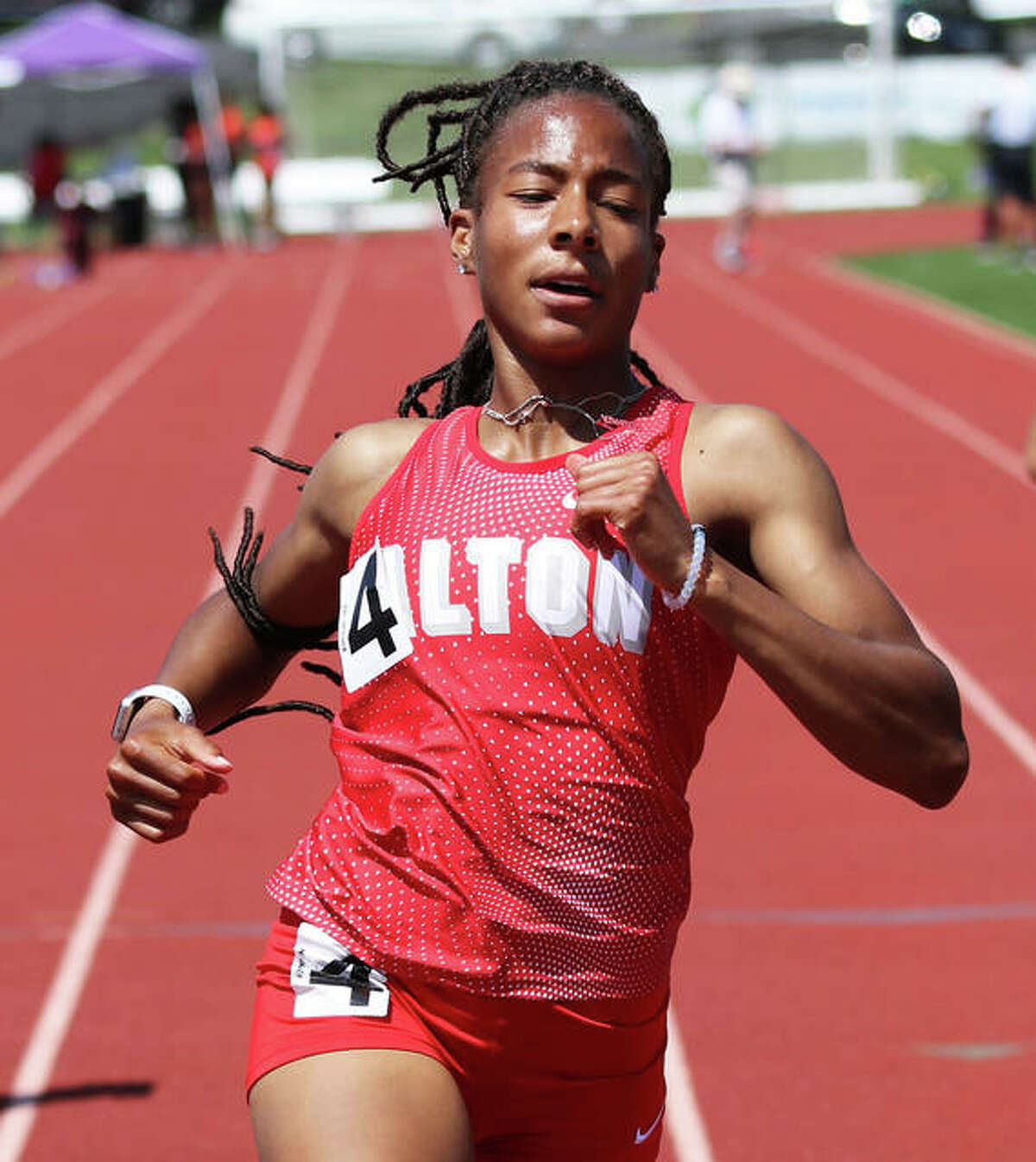 Alton’s Renee Raglin crosses the finish line to win the 100 at the SWC Meet last season at Collinsville.