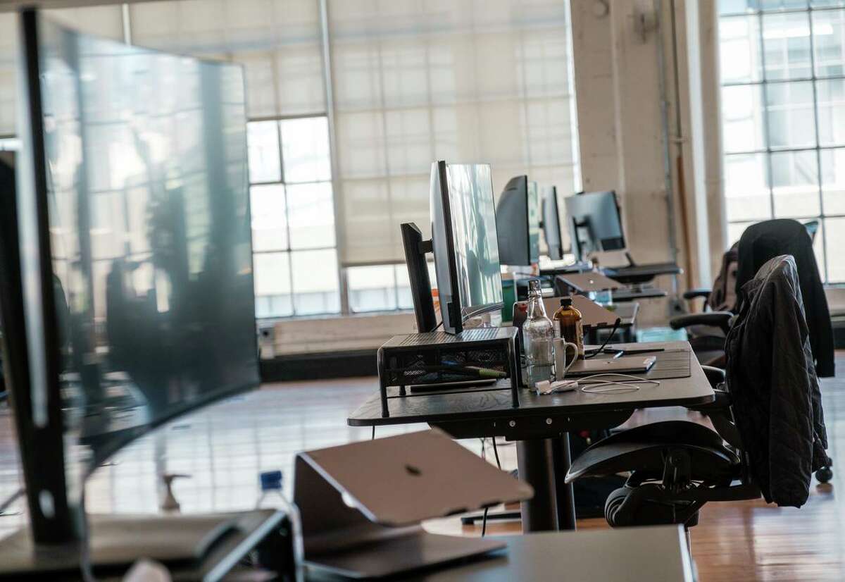 Workstations remain empty at the Fast office space in San Francisco in July. While working remotely has helped kept many of San Francisco’s high-paid employees safe, it is having an ill effect on the city’s tax revenue, potentially siphoning off millions of dollars per year.