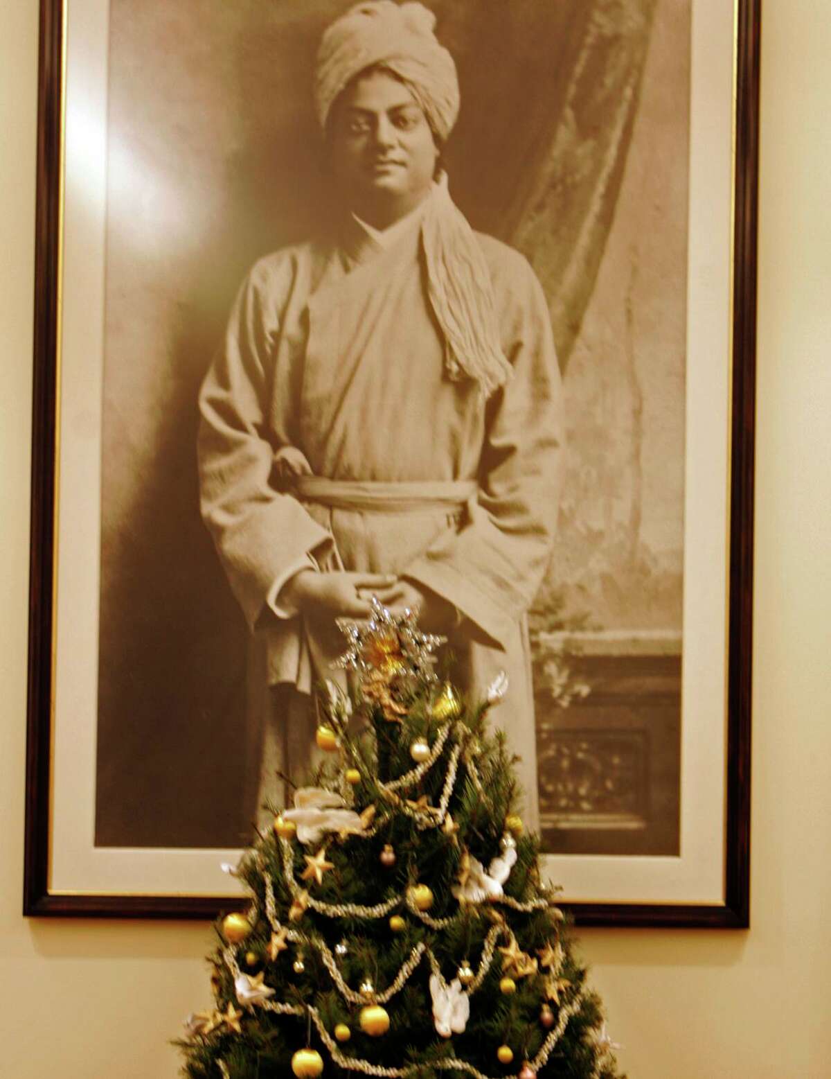 A photograph of Swami Vivekananda hangs behind a Christmas tree in 2005 at the Vedanta Society temple on Vallejo Street.
