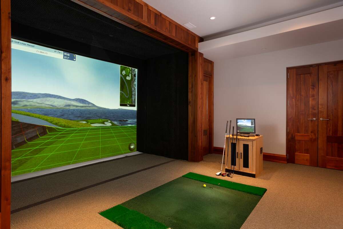 The home on 46 June Road in Washington, Conn. has a room dedicated to a Full Swing golf simulator. 