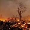 Buildings burn as the Dixie Fire tears through the Greenville community of Plumas County, Calif., on Wednesday, Aug. 4, 2021. The fire leveled multiple historic buildings and dozens of homes in central Greenville.