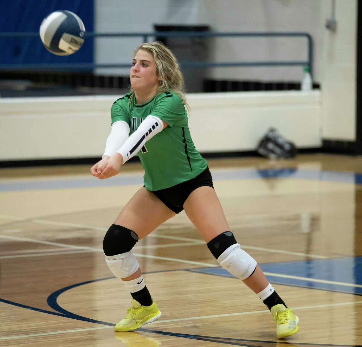 Willis sophomore Caroline Woodfill (1) returns the ball during the fourth set of a non-district volleyball match at New Caney High School, Tuesday, Sept. 15, 2020.