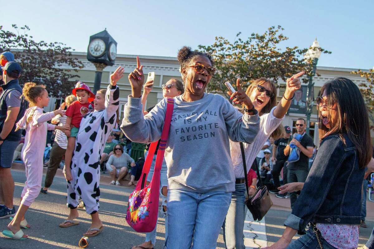 Michele Callwood (center) dances with her longtime friends Michelle Jeffers (right) and Moy Chiu (far right) during Novato’s Rock the Block street party. News of a new housing development at the nearby Fireman’s Fund campus could spur more activity in the Marin County city.