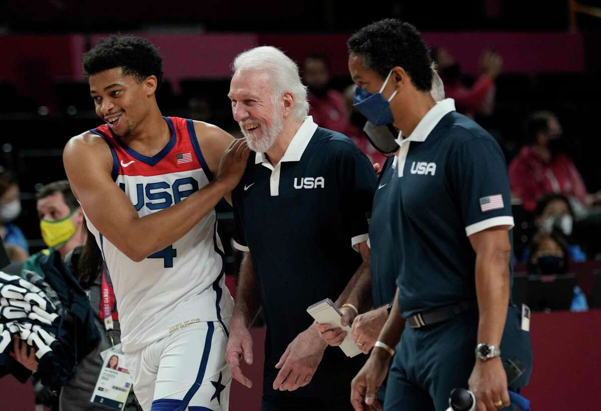 United States's Keldon Johnson (4), left, and head coach Gregg Popovich, center, celebrate after their win in the men's basketball semifinal game against Australia at the 2020 Summer Olympics, Thursday, Aug. 5, 2021, in Saitama, Japan. (AP Photo/Eric Gay)