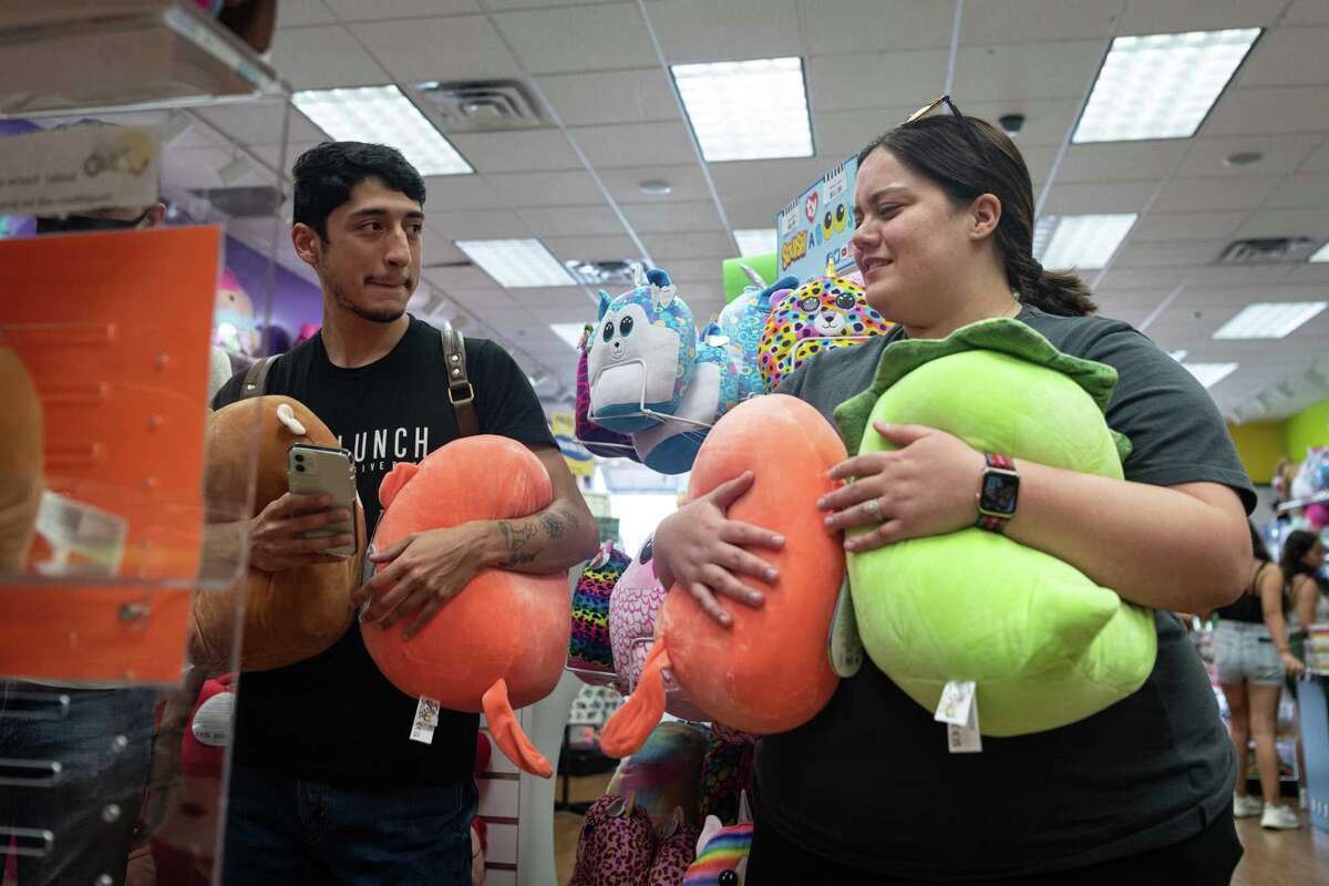 Adrian Hernandez, left, and Aubree Molina shop for Squishmallows at the Learning Express store in the Alamo Quarry Market. The two came to the store as soon as they read about the new stock arrivals on a Squishmallows online group chat.
