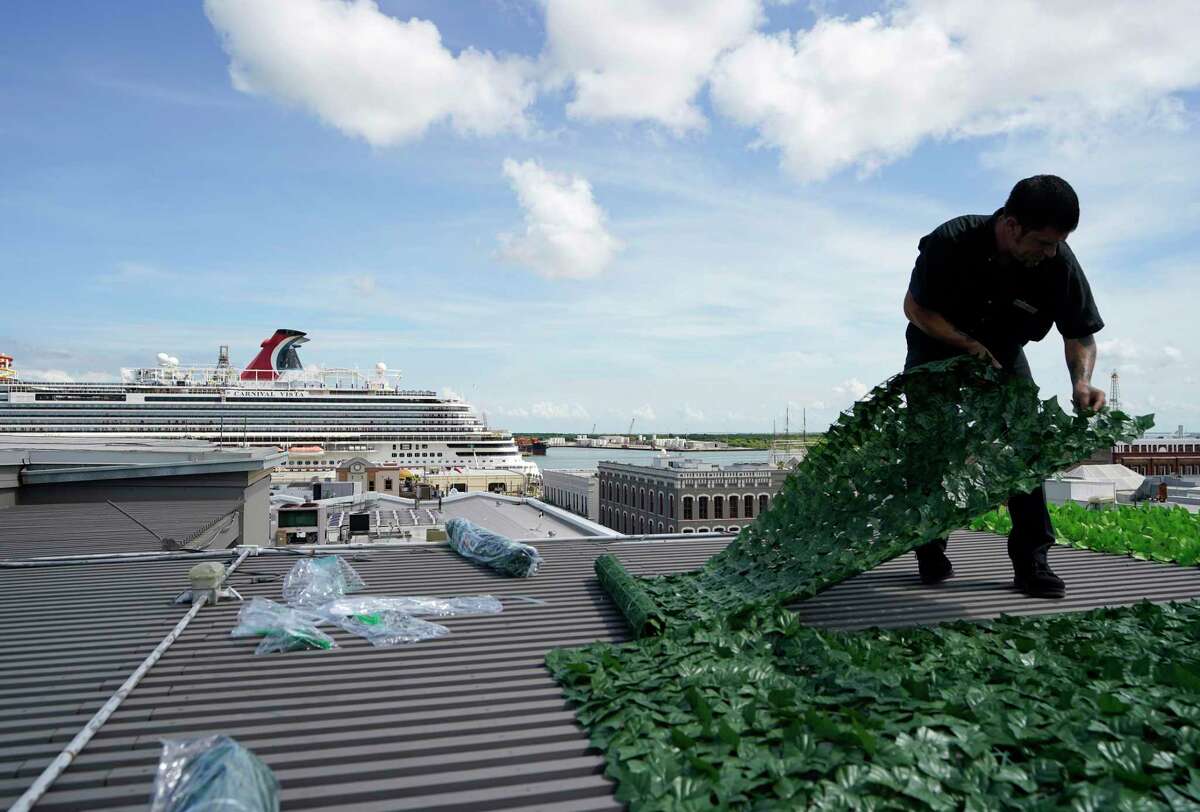 The Carnival Vista is shown at the Port of Galveston as A.J. Ites, with maintenance and engineering, attached artificial foliage on top of the pergola on The Rooftop at The Tremont House, 2300 Ship Mechanic Row St., Friday, July 2, 2021 in Galveston. The Carnival Vista was the first cruise to sail out of Galveston since the pandemic.