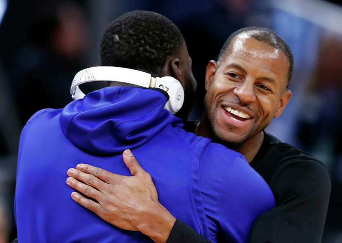 The Heat's Andre Iguodala greets former Warriors teammate Draymond Green in 2020.