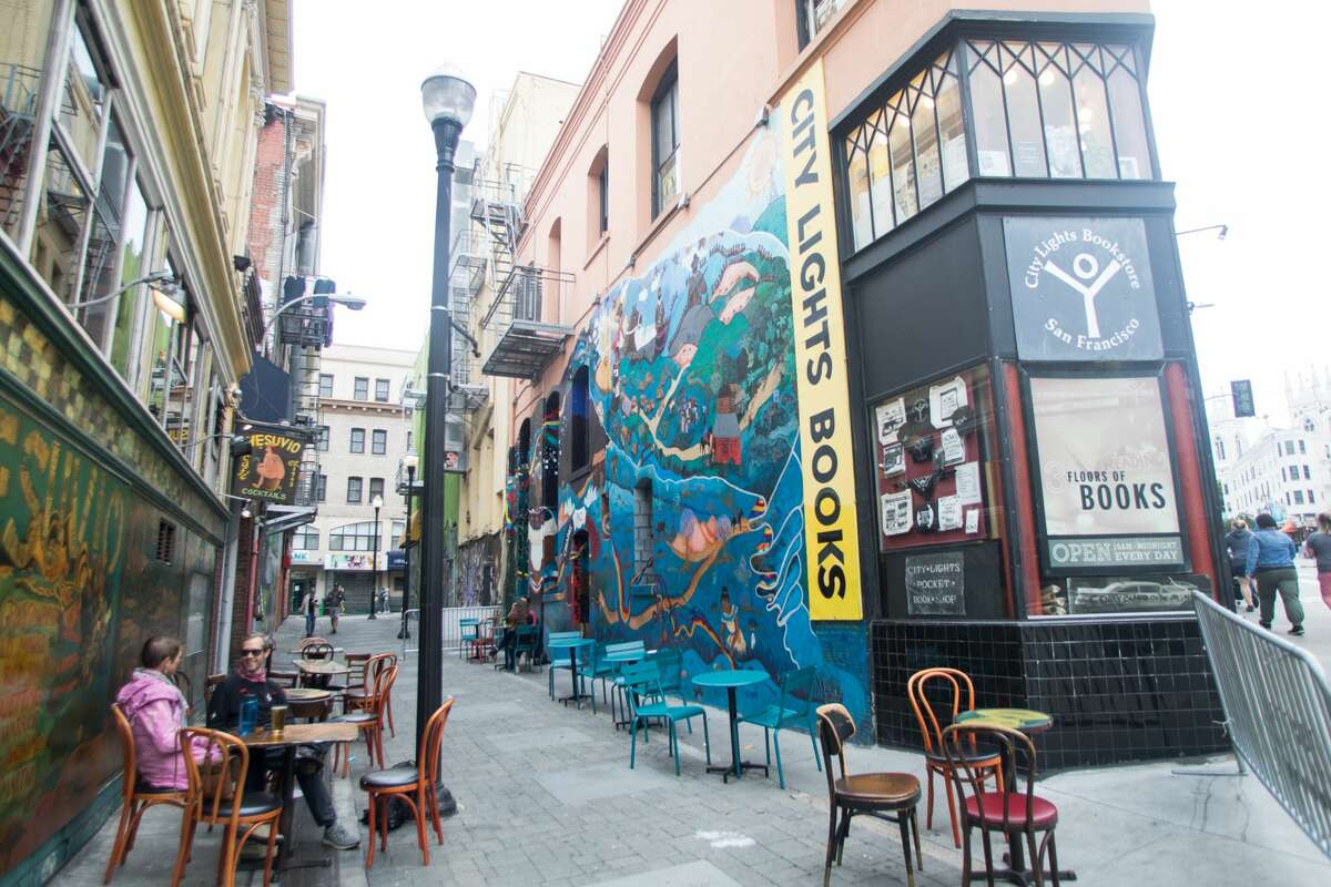 People enjoy a drink at Vesuvio Cafe in Jack Kerouac Alley in San Francisco, Calif. on August 6, 2021.