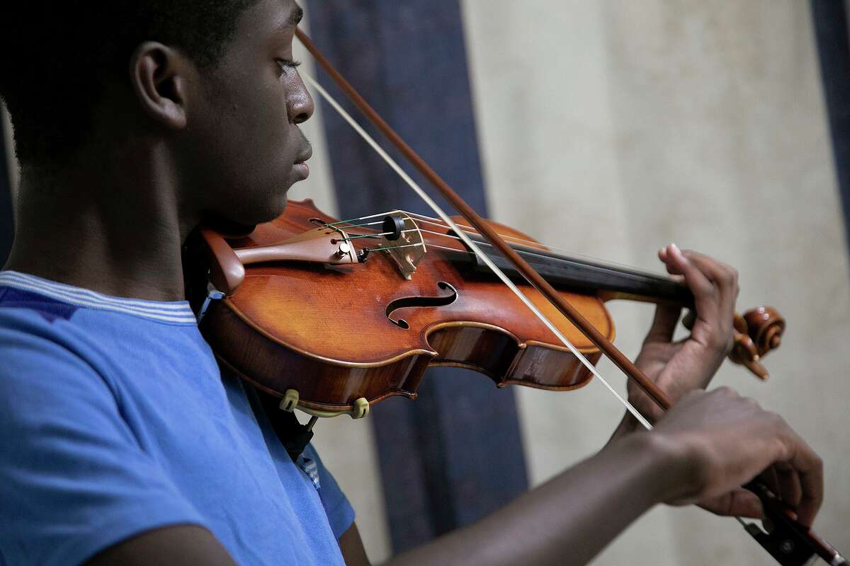 Samuel Igbo, 15, practices in a bathroom, where the acoustics are better than other rooms, at his home in Boerne. He is already practicing for his next audition this fall for Carnegie Hall’s National Youth Orchestra.