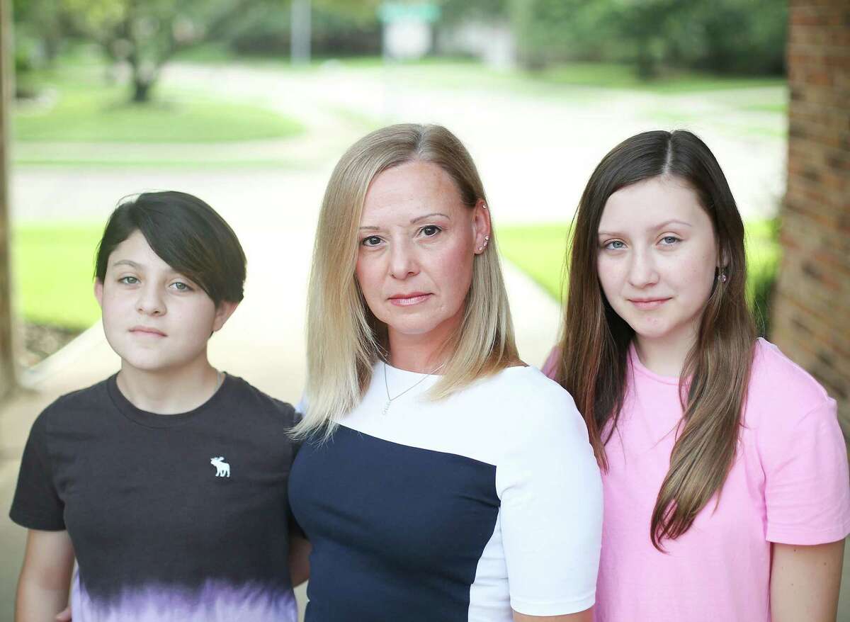 Lee Nelson, center, with her daughters, Hope, 10, left, and Ashlee, 13, outside their Katy home on Tuesday, Aug. 3, 2021. Both daughters go to Katy ISD schools and as they get ready to go back to in-person learning, Lee is worried for Hope, who cannot be vaccinated yet. She created a petition with more than 1,000 signatures so far for her district to either require masks for kids under 12 or offer virtual learning options.