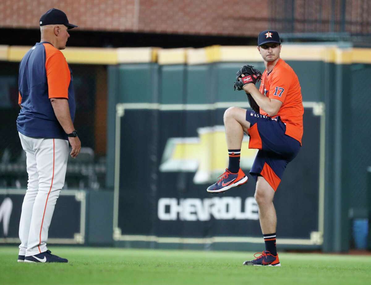 Houston Astros pitching coach Brent Strom (56) watches Jake Odorizzi throw during batting practice before an MLB baseball game at Minute Maid Park, Friday, August 6, 2021, in Houston.
