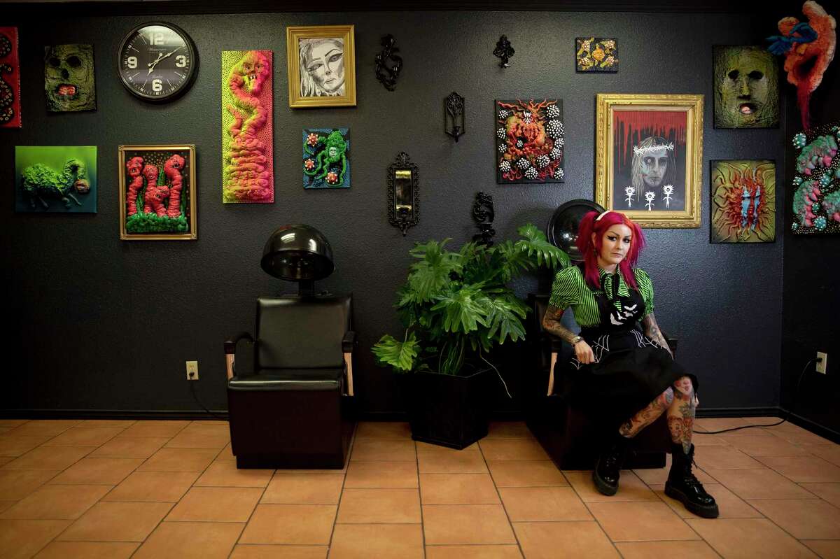 San Antonio hairstylist and horror artist Crystal Terror (née Duron) sits in front of her artwork at Toxic Salon, her hair-styling business she founded in 2014.