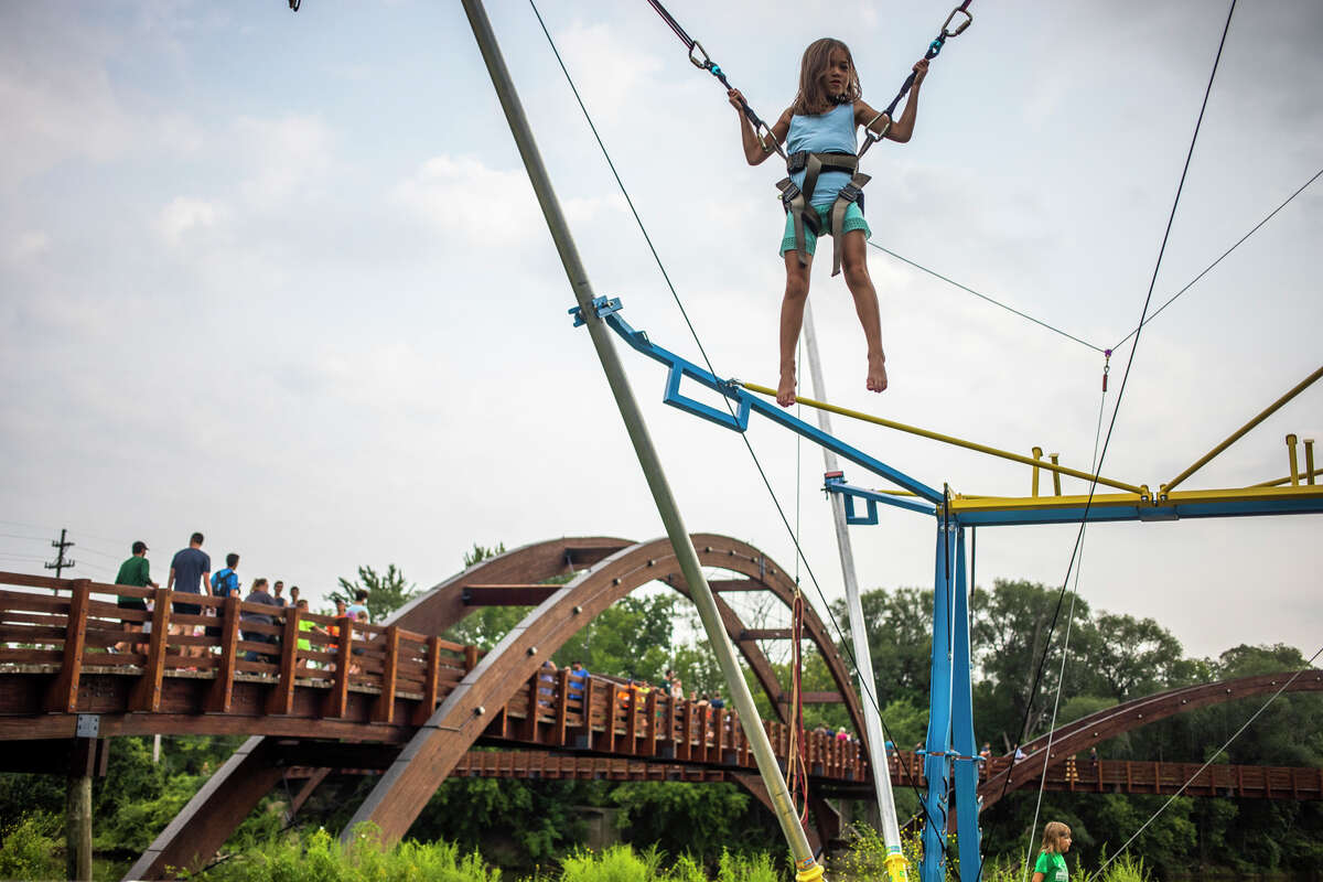 Thousands of people flock to Chippewassee Park to enjoy games, food and drink, live music, hot air balloons and more during the River Days Festival Friday, Aug. 6, 2021 in downtown Midland. (Katy Kildee/kkildee@mdn.net)