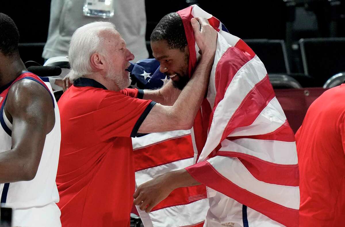United States' Kevin Durant (7), right, celebrates with head coach Gregg Popovich after their win in the men's basketball gold medal game against France at the 2020 Summer Olympics, Saturday, Aug. 7, 2021, in Saitama, Japan. (AP Photo/Luca Bruno)