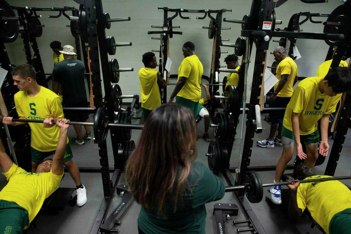 Sharpstown High School Strength and Conditioning Coach Aislinn Garza works with the football team during a training session Wednesday, Aug. 4, 2021, in Houston. Garza is the only female strength and conditioning coach in Houston.